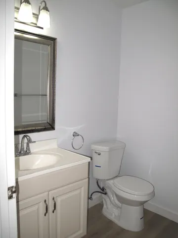 a bathroom with a toilet sink and mirror