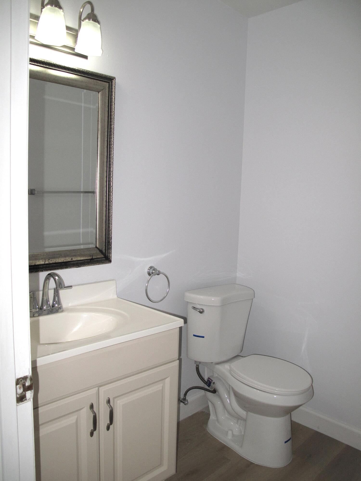 1102 North Drive, Unit C Delray Beach, FL 33445 - Photo 14 of 36 a bathroom with a toilet sink and mirror