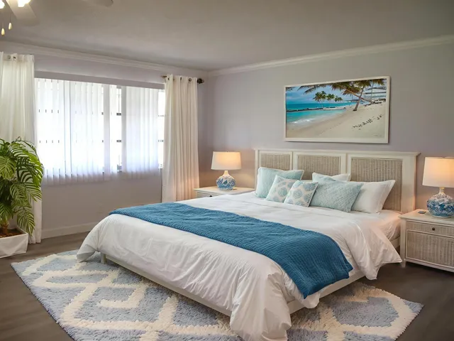 a bedroom with a large bed and a potted plant