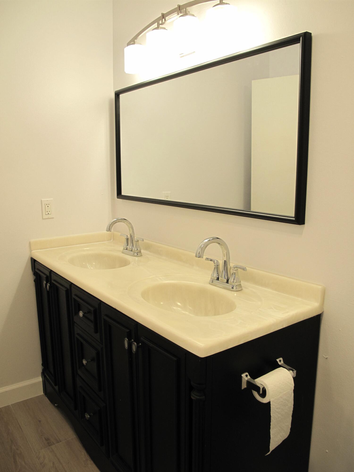 1102 North Drive, Unit C Delray Beach, FL 33445 - Photo 17 of 36 a bathroom with a sink and a mirror