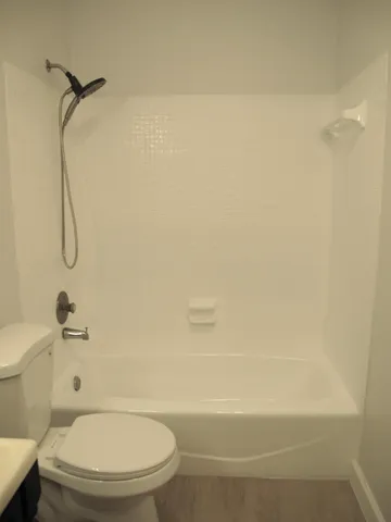 a bathroom with a toilet and a shower