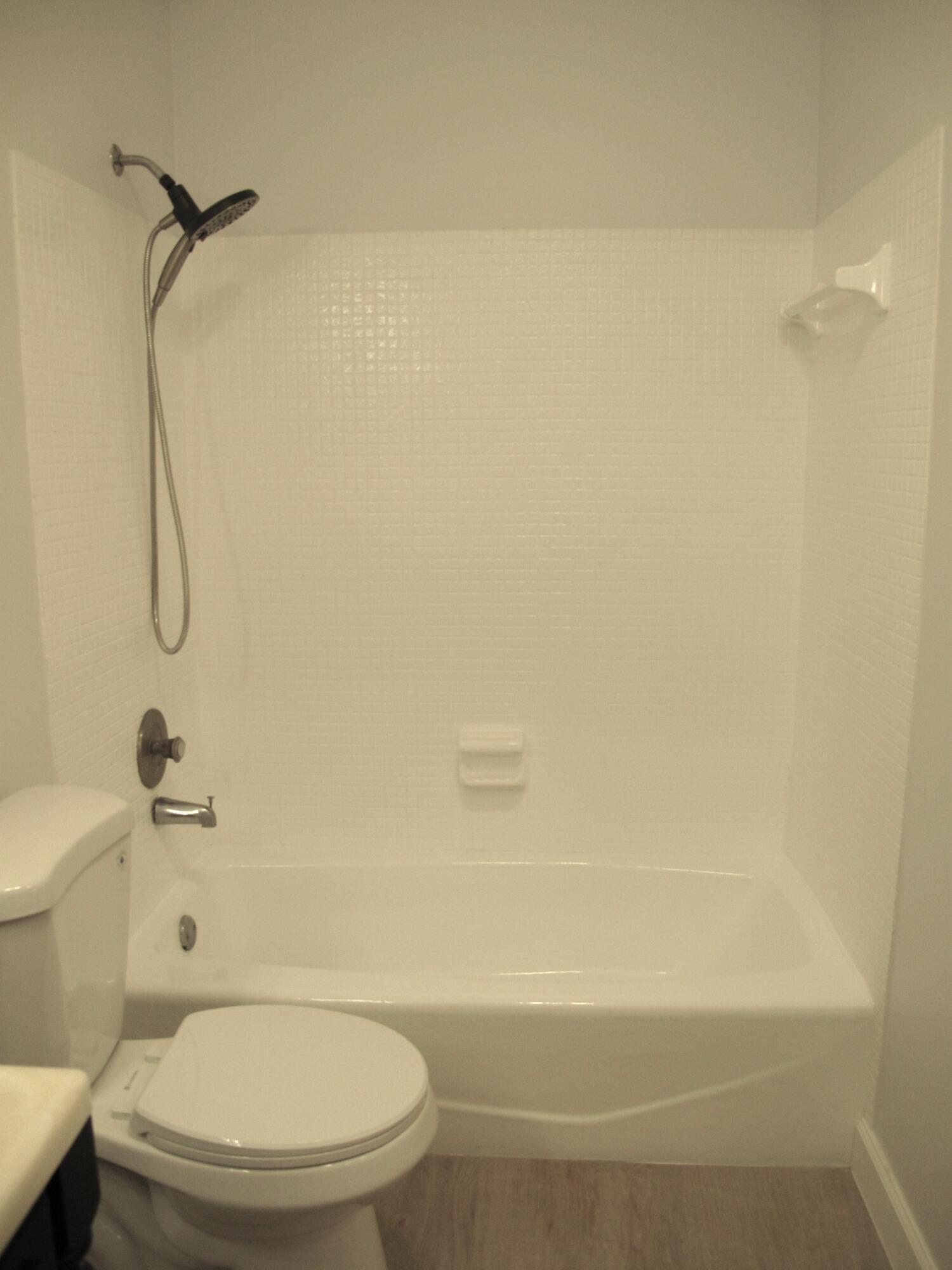 1102 North Drive, Unit C Delray Beach, FL 33445 - Photo 18 of 36 a bathroom with a toilet and a shower