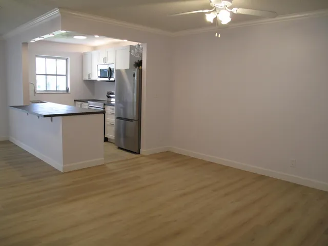 a view of a kitchen with a sink cabinets and wooden floor