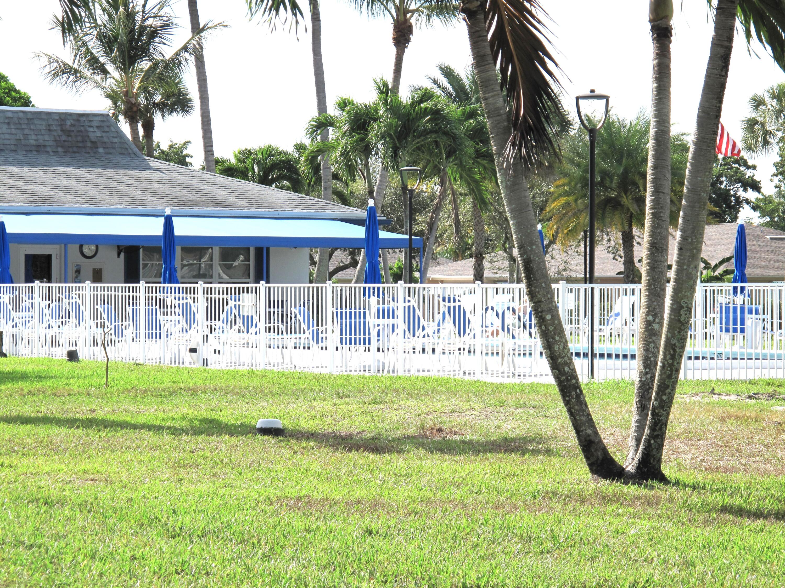 1102 North Drive, Unit C Delray Beach, FL 33445 - Photo 24 of 36 a front view of a house with garden
