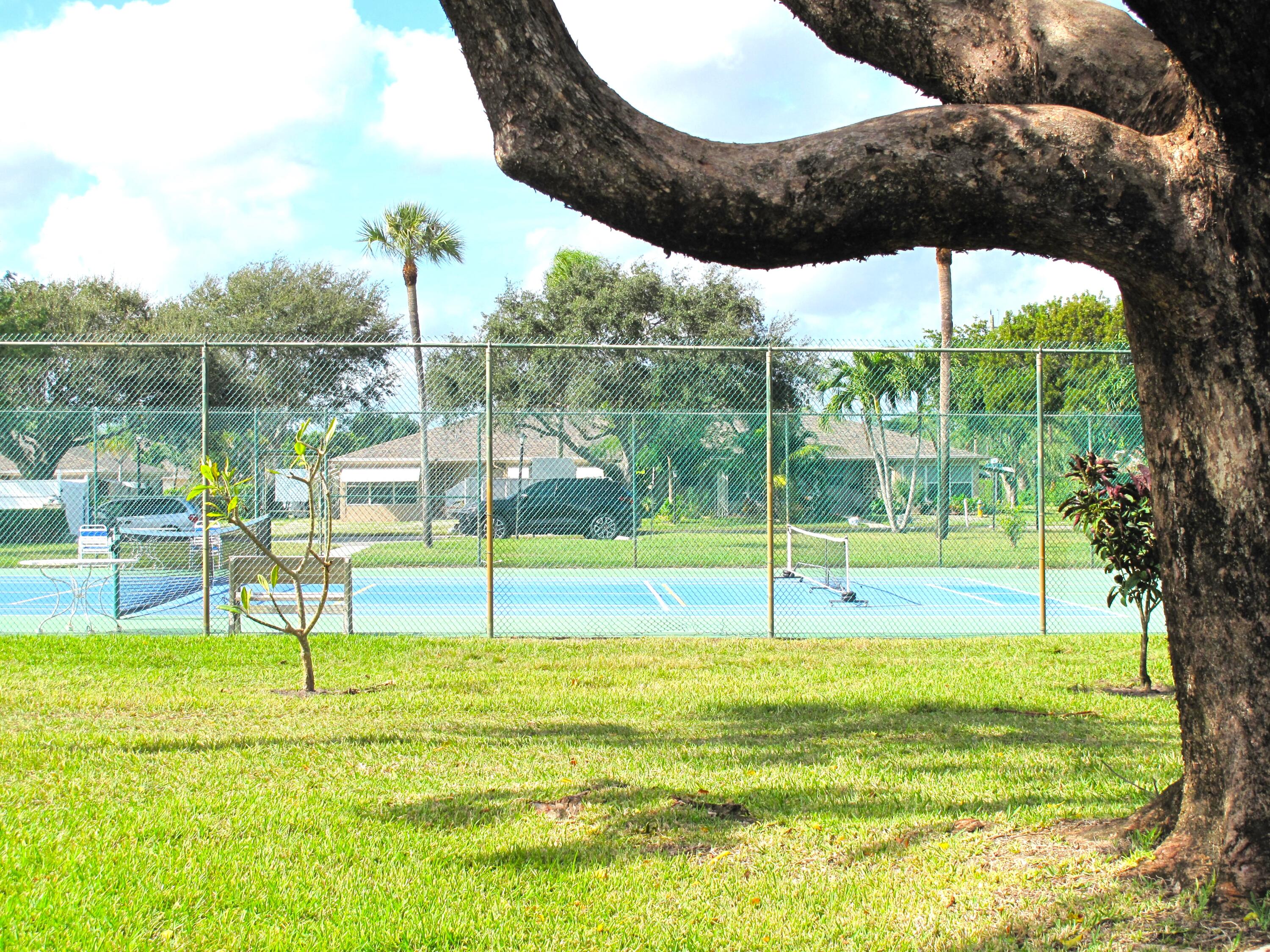 1102 North Drive, Unit C Delray Beach, FL 33445 - Photo 25 of 36 a view of a swimming pool with a patio