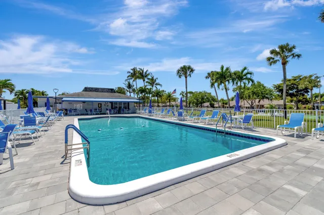 a view of swimming pool with outdoor seating and plants