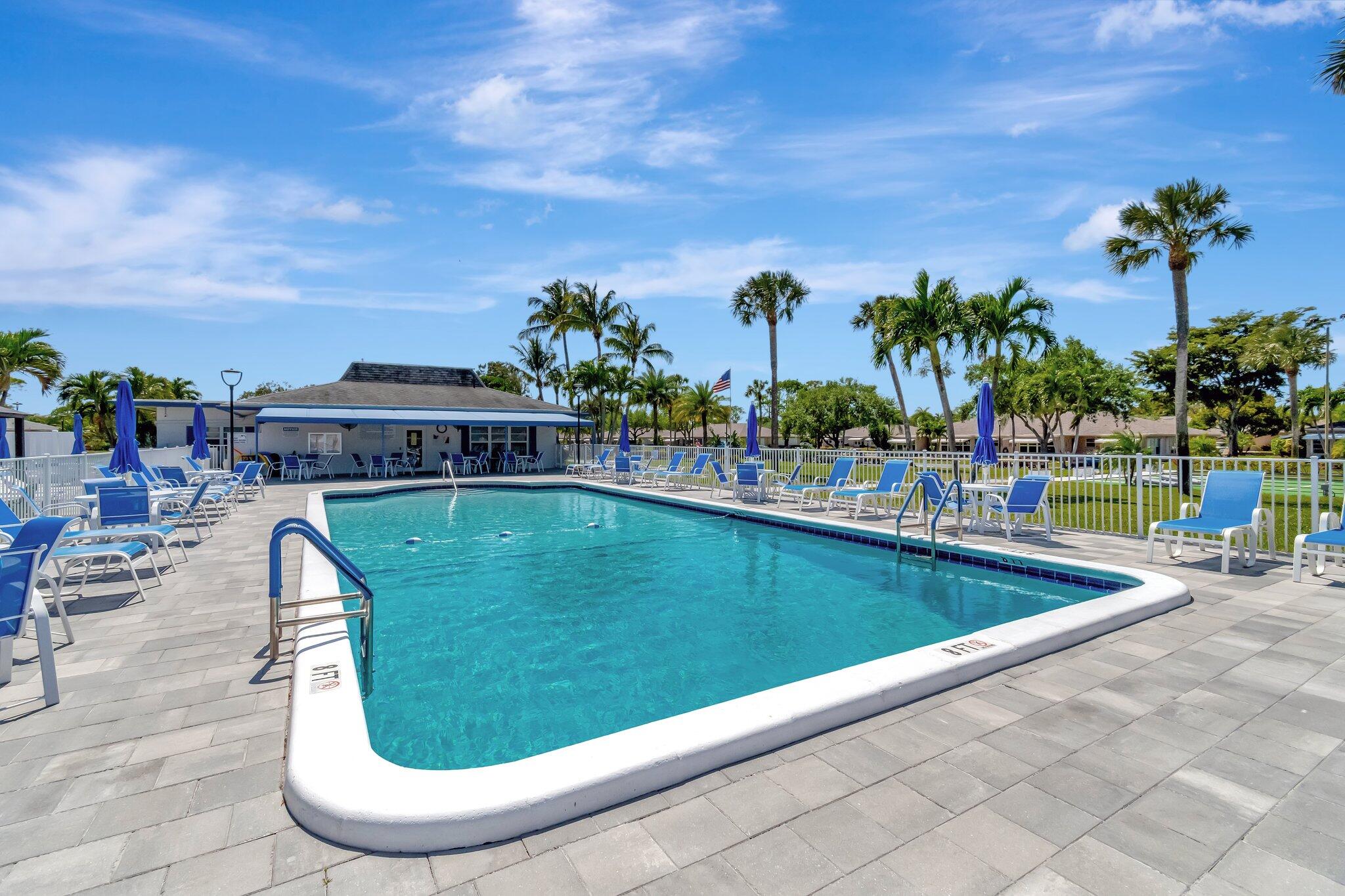 1102 North Drive, Unit C Delray Beach, FL 33445 - Photo 28 of 36 a view of swimming pool with outdoor seating and plants