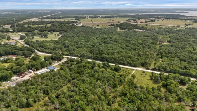 an aerial view of residential houses with outdoor space and mountain view