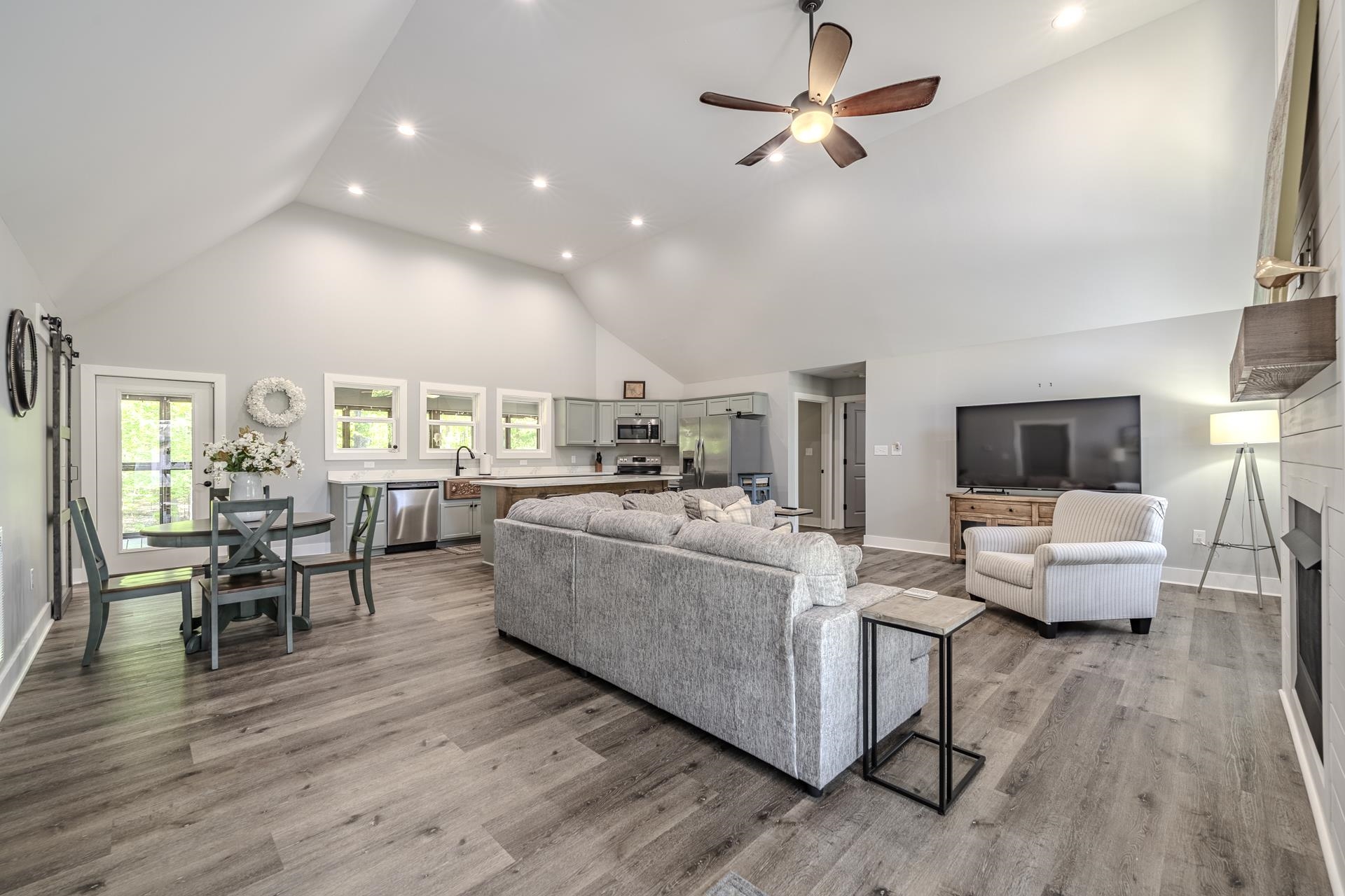 120 Rustic Trail Counce, TN 38326 - Photo 11 of 29 Living room featuring a high ceiling, recessed lighting, a ceiling fan, a fireplace, and light wood-type flooring