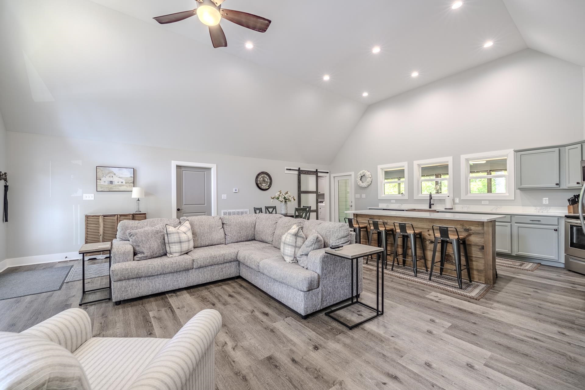 120 Rustic Trail Counce, TN 38326 - Photo 13 of 29 Living area with vaulted ceiling, recessed lighting, light wood finished floors, and ceiling fan