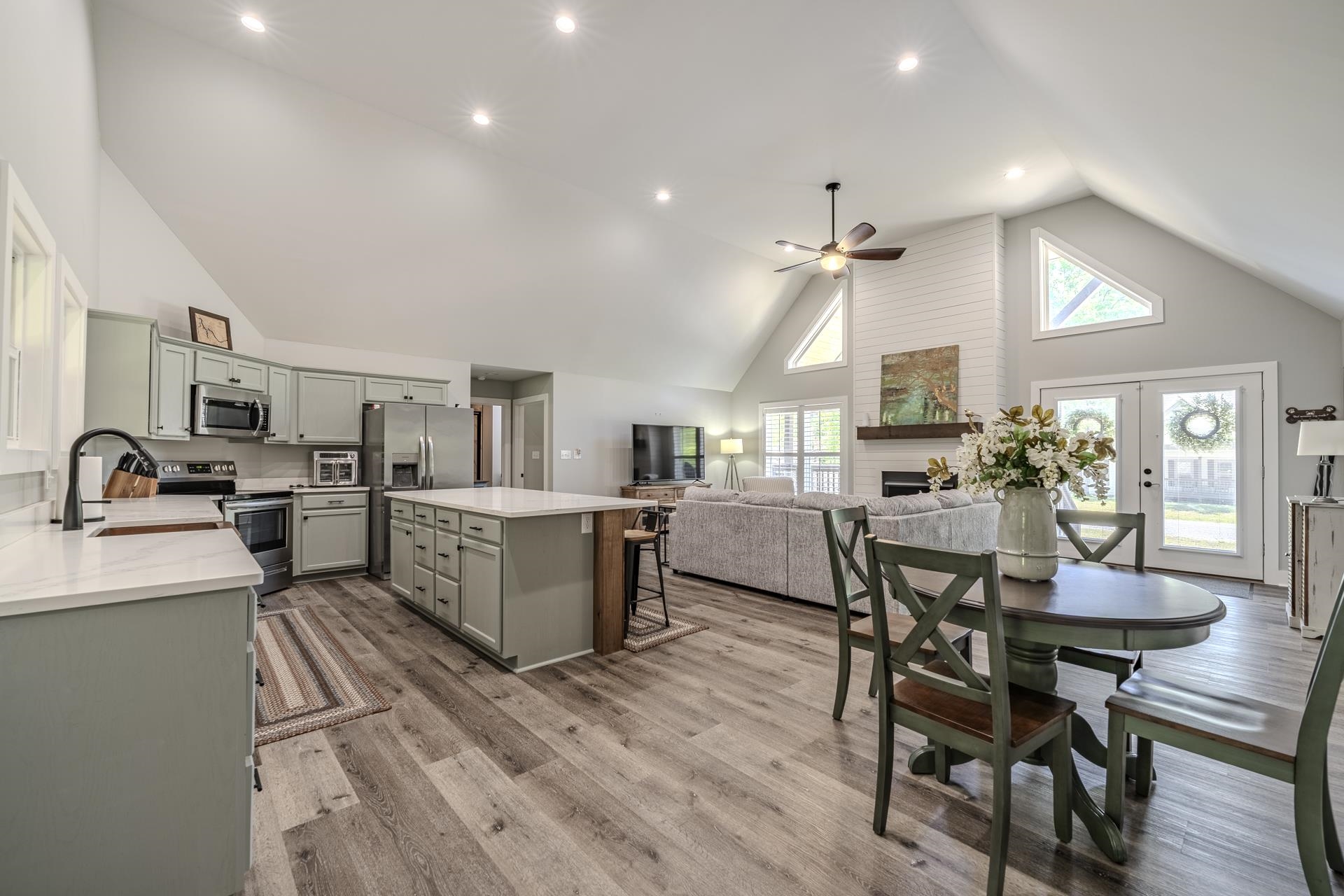 120 Rustic Trail Counce, TN 38326 - Photo 14 of 29 Dining room featuring a high ceiling, ceiling fan, light wood-style flooring, a large fireplace, and recessed lighting