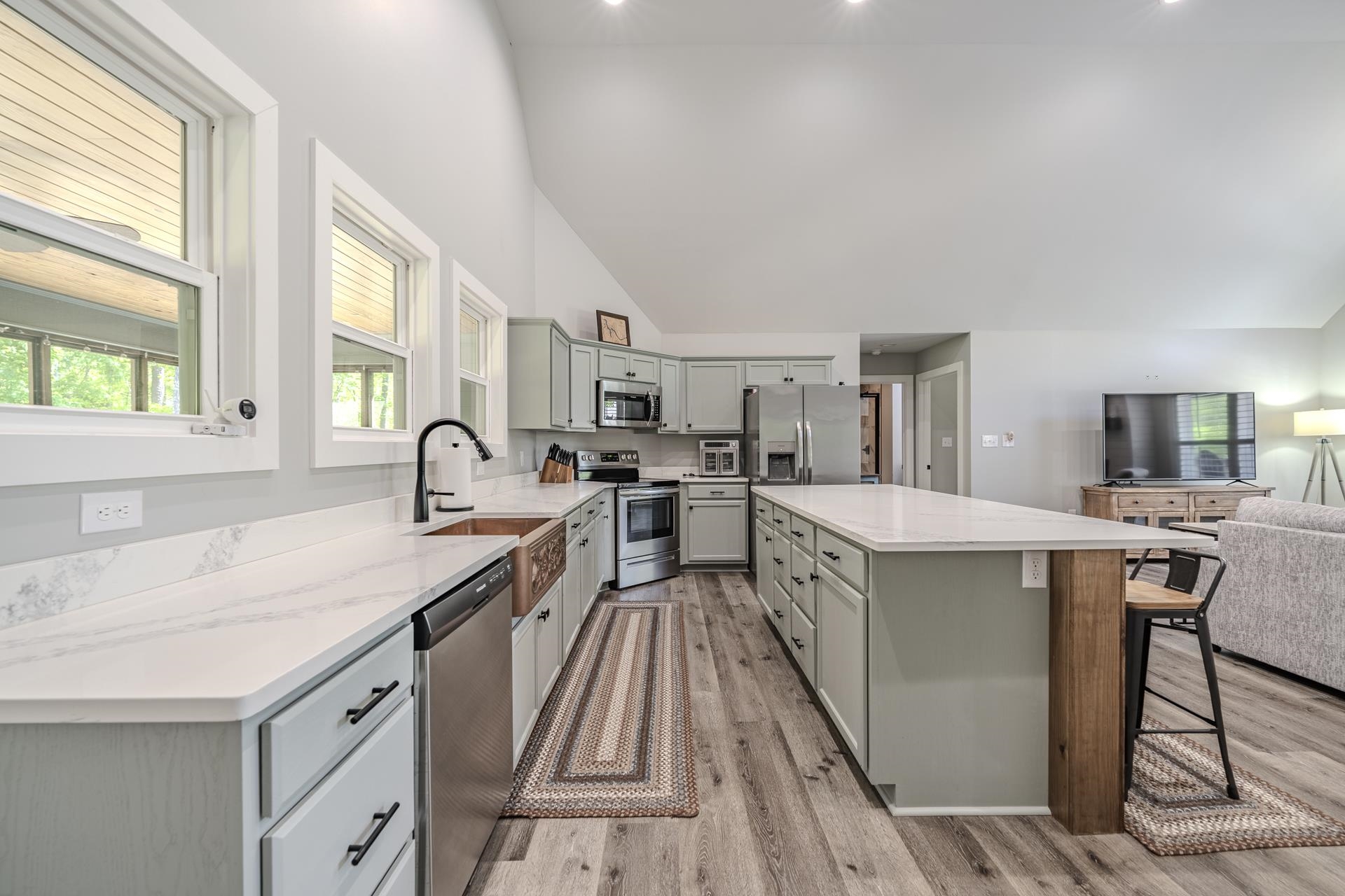 120 Rustic Trail Counce, TN 38326 - Photo 29 of 29 Kitchen featuring a kitchen island, stainless steel appliances, open floor plan, lofted ceiling, and a breakfast bar area