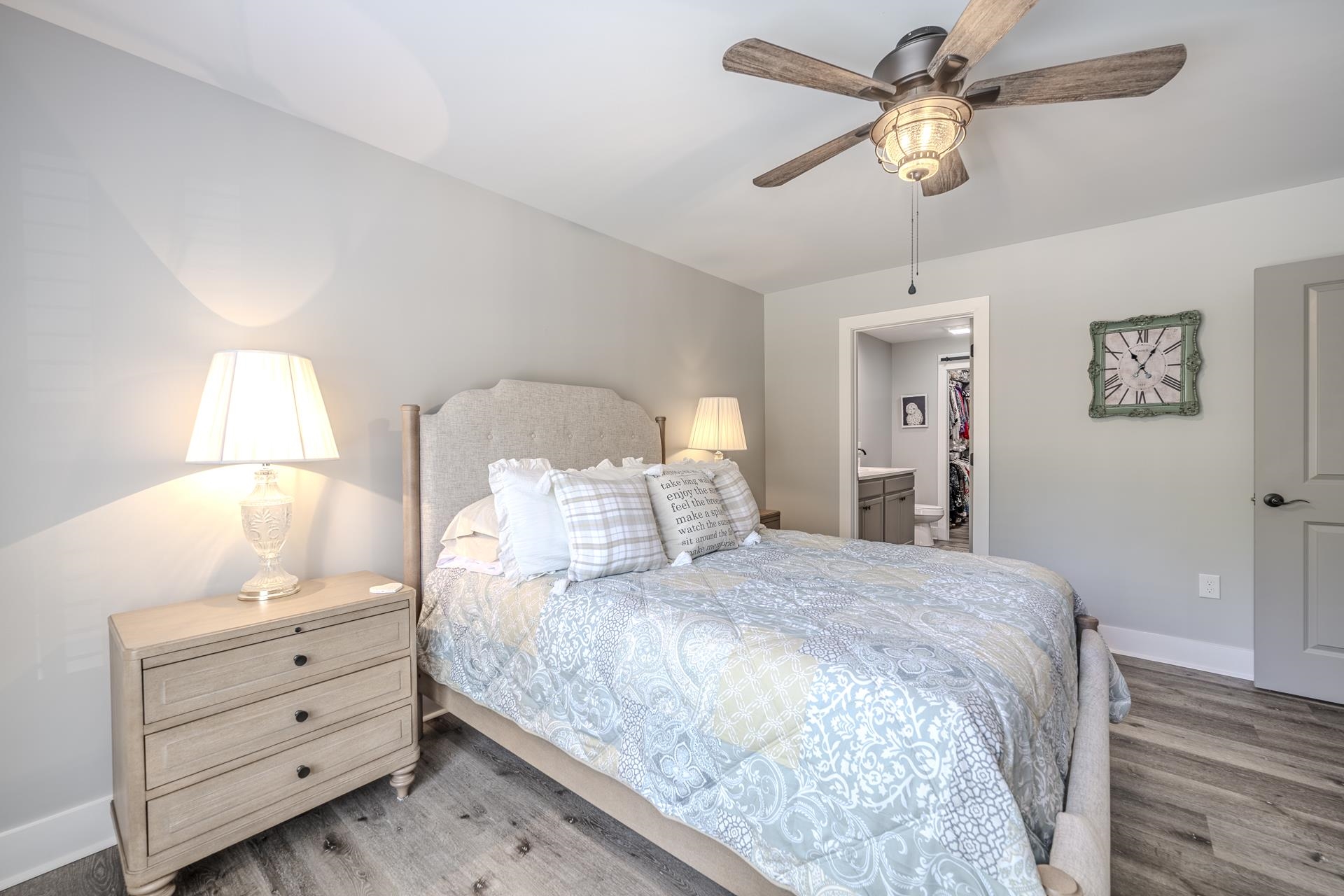 120 Rustic Trail Counce, TN 38326 - Photo 18 of 29 Bedroom with light wood-style flooring, a ceiling fan, a spacious closet, and ensuite bath