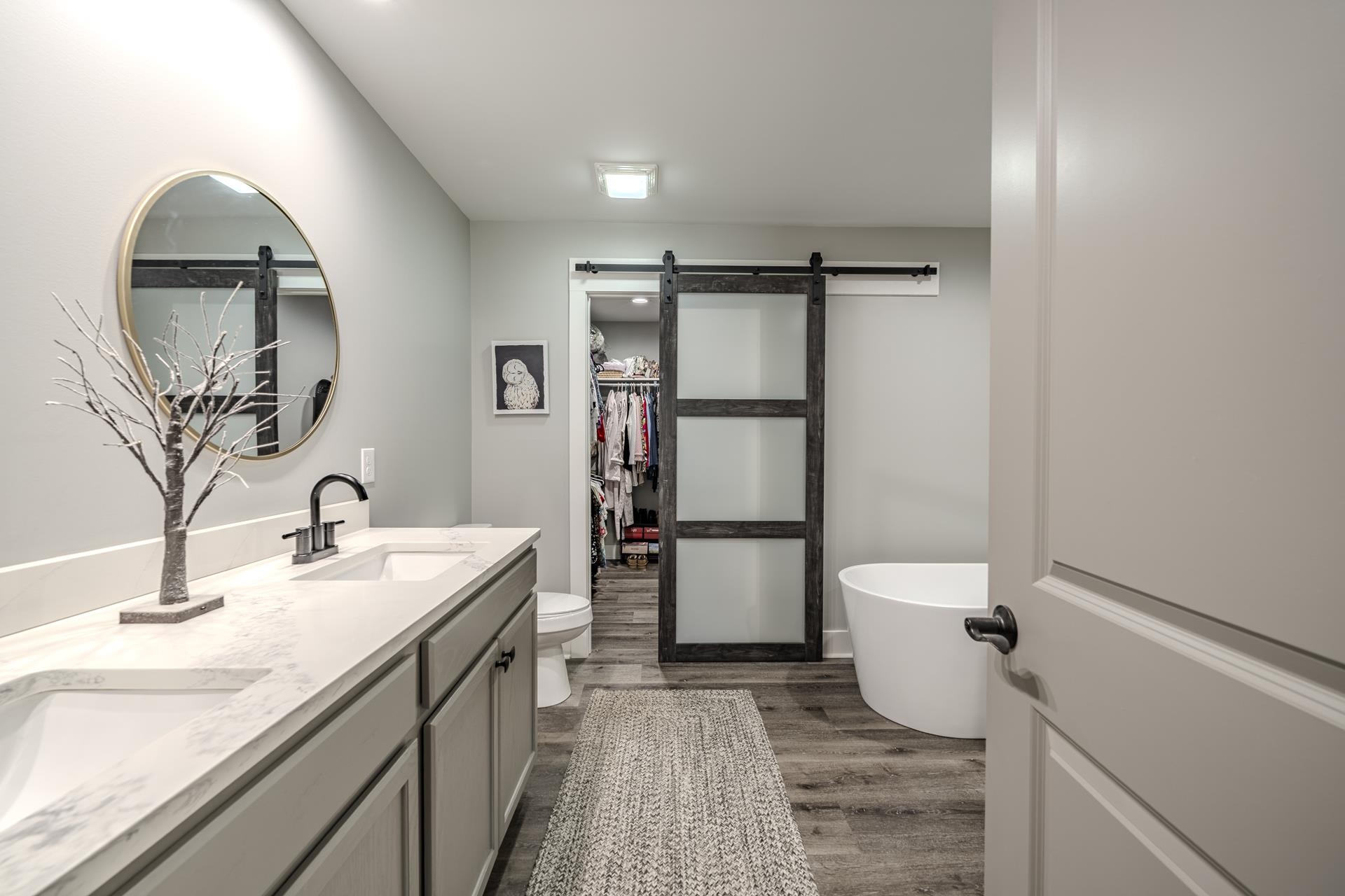 120 Rustic Trail Counce, TN 38326 - Photo 19 of 29 Bathroom featuring double vanity, a freestanding bath, dark wood-style flooring, and a walk in closet