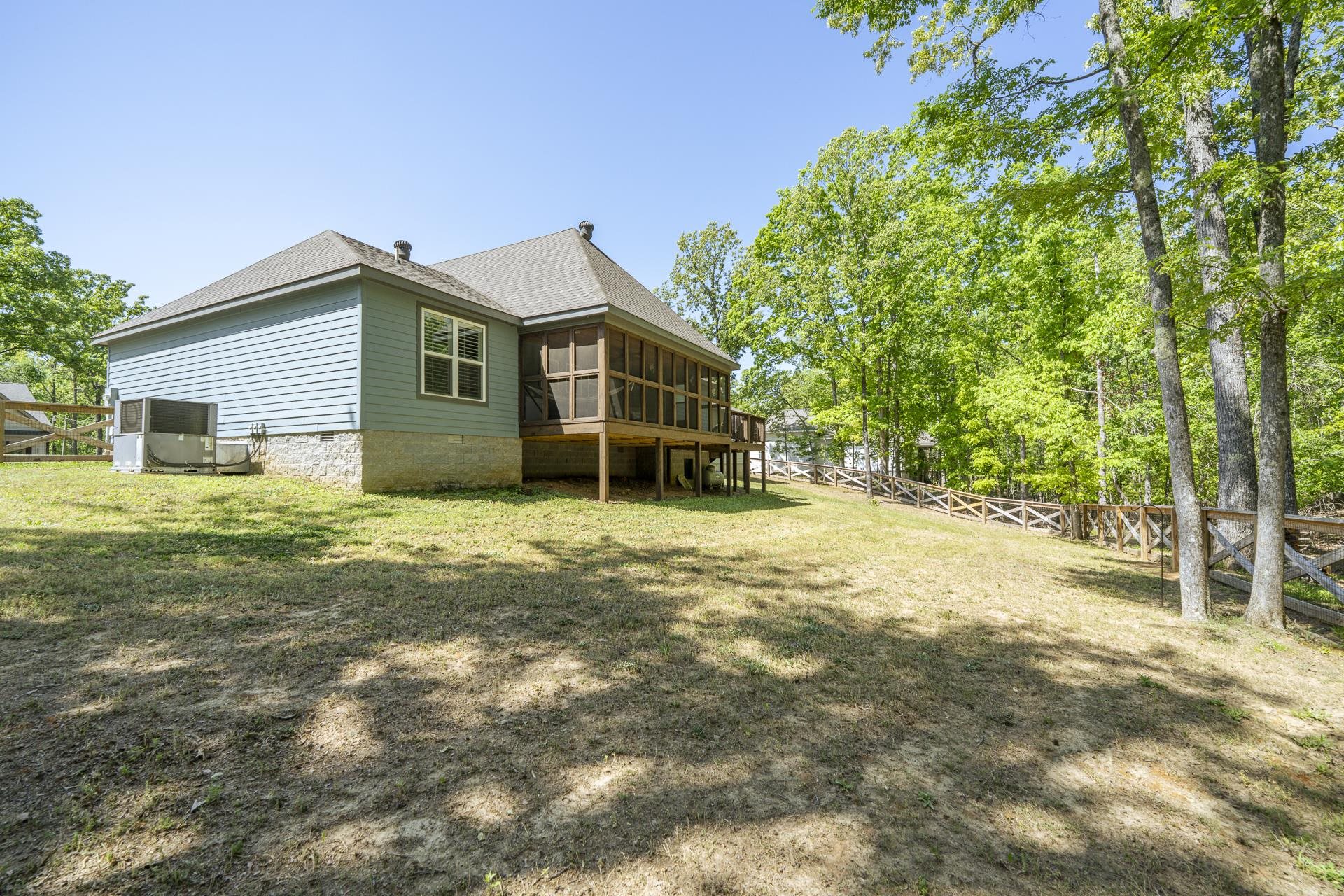 120 Rustic Trail Counce, TN 38326 - Photo 6 of 29 Rear view of house featuring a sunroom, roof with shingles, a fenced backyard, and crawl space