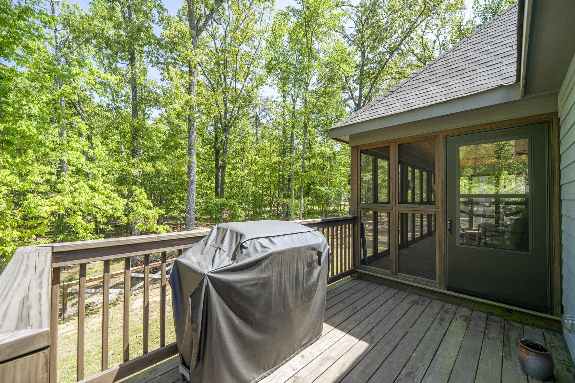 120 Rustic Trail Counce, TN 38326 - Photo 9 of 29 Wooden deck with a sunroom, area for grilling, and view of scattered trees