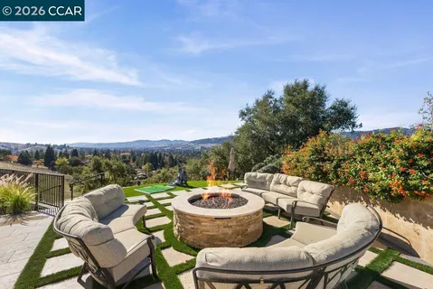a view of a patio with a table chairs and a backyard