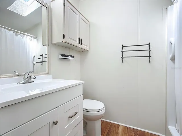 a bathroom with a sink a toilet and vanity
