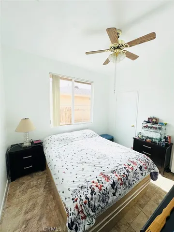 a bedroom with a bed and window