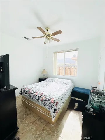 a bedroom with a bed dresser and a window