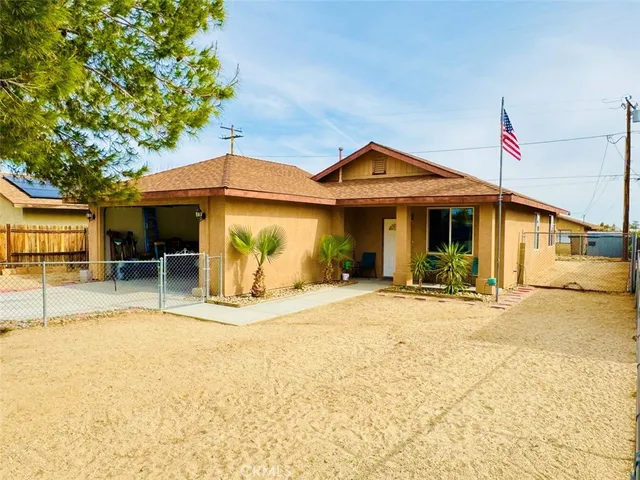 a front view of a house with basket ball court and a garage