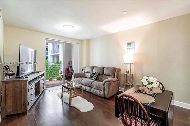 a living room with furniture a flat screen tv and a large window