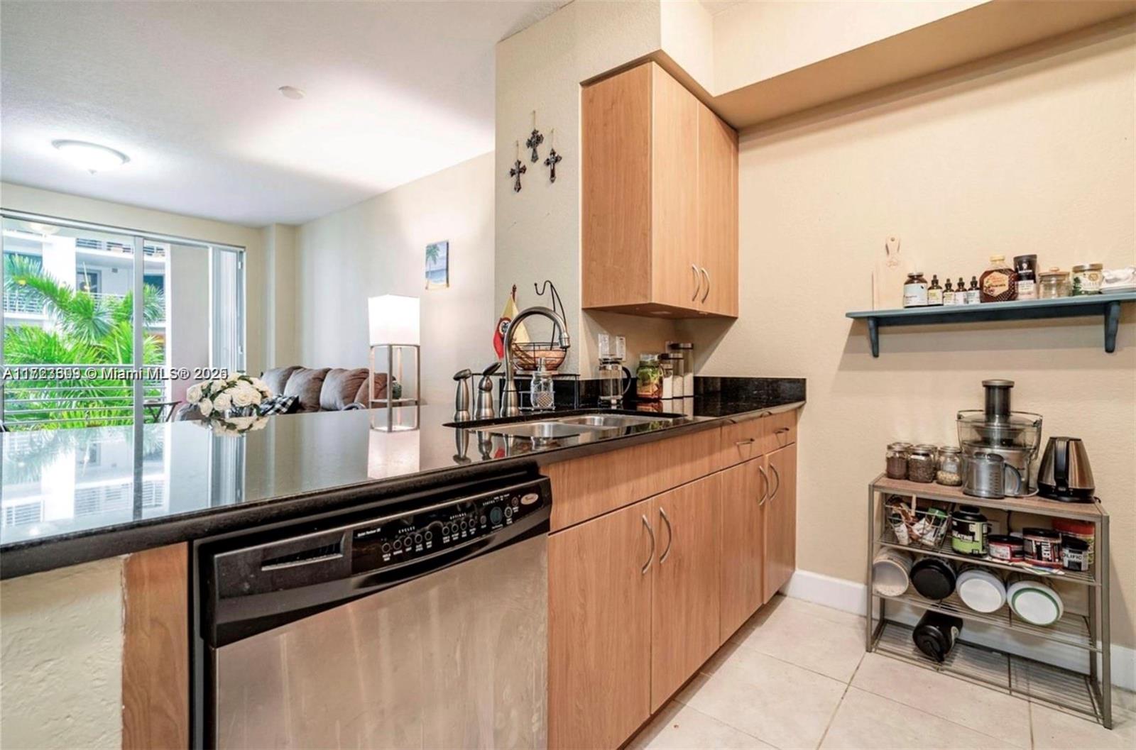 1830 Radius Drive, Unit 516 Hollywood, FL 33020 - Photo 24 of 28 a kitchen with stainless steel appliances a sink and a large window