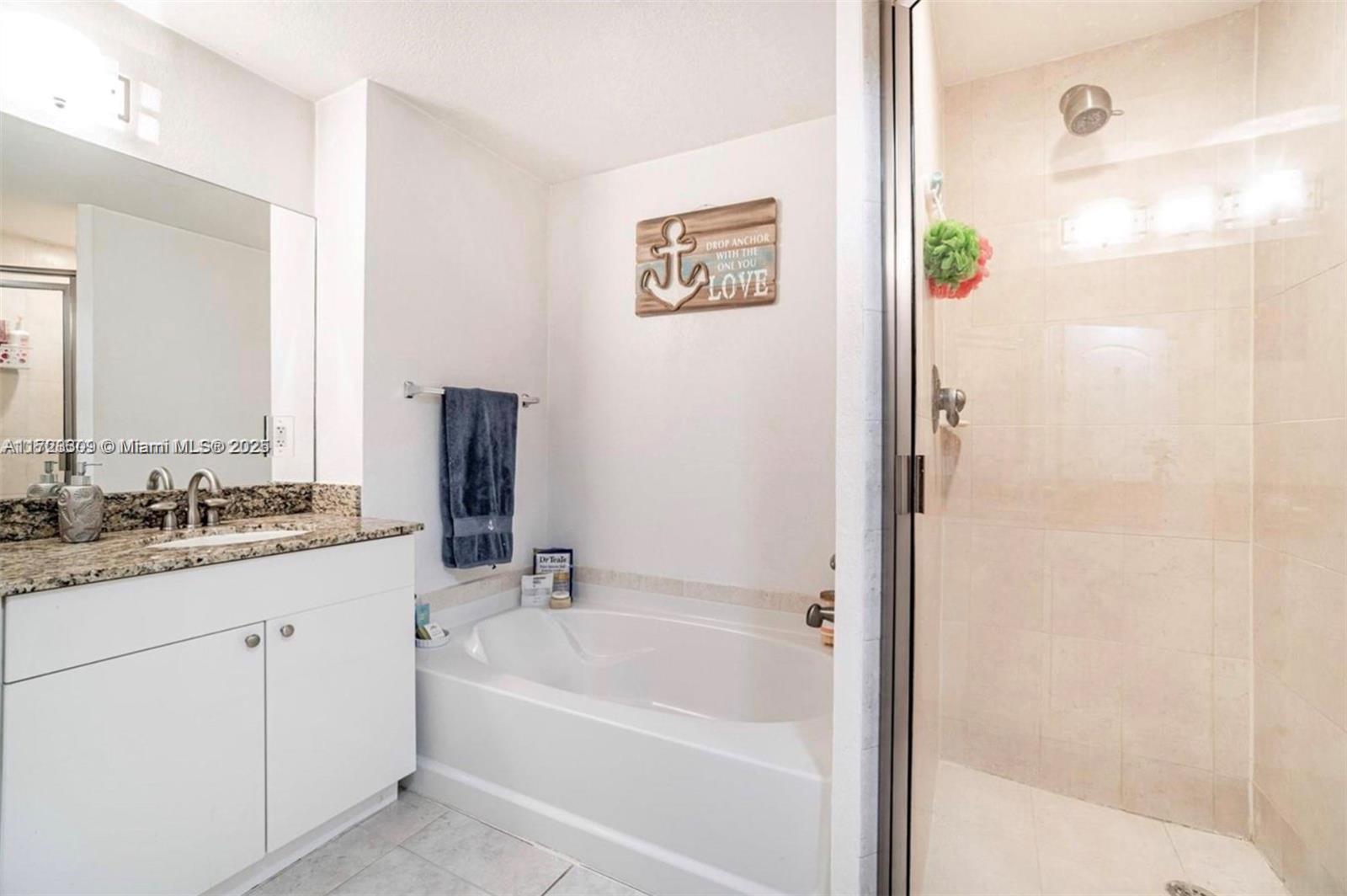 1830 Radius Drive, Unit 516 Hollywood, FL 33020 - Photo 26 of 28 a bathroom with a granite countertop sink a bathtub and a shower