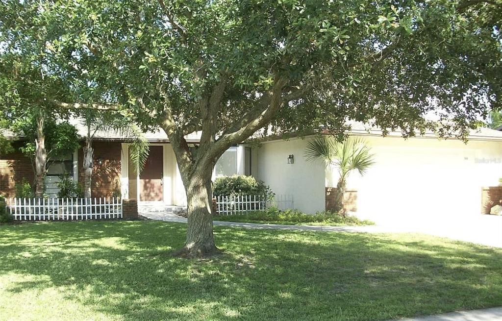 1649 Georgetowne Boulevard Sarasota, FL 34232 - Photo 8 of 8 a front view of a house with a garden