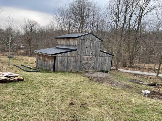 1054 Eakin Road Emlenton, PA 16373 - Photo 14 of 15 a backyard of a house with lots of green space and outdoor seating