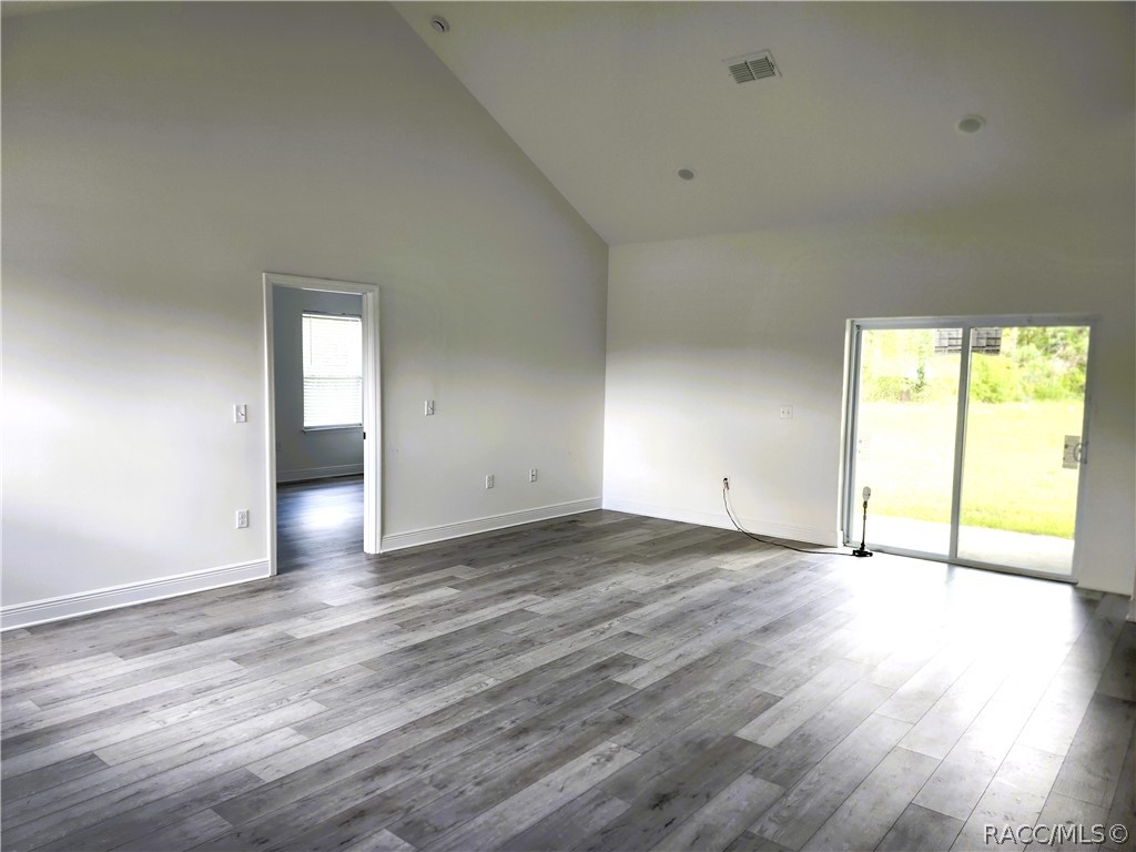 2800 Southwest 139th Street Ocala, FL 34473 - Photo 2 of 16 a view of an empty room with wooden floor and a window