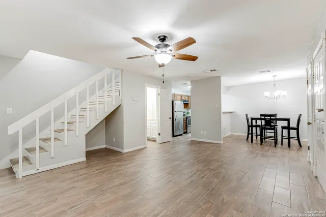 a view of a livingroom with furniture and a workspace