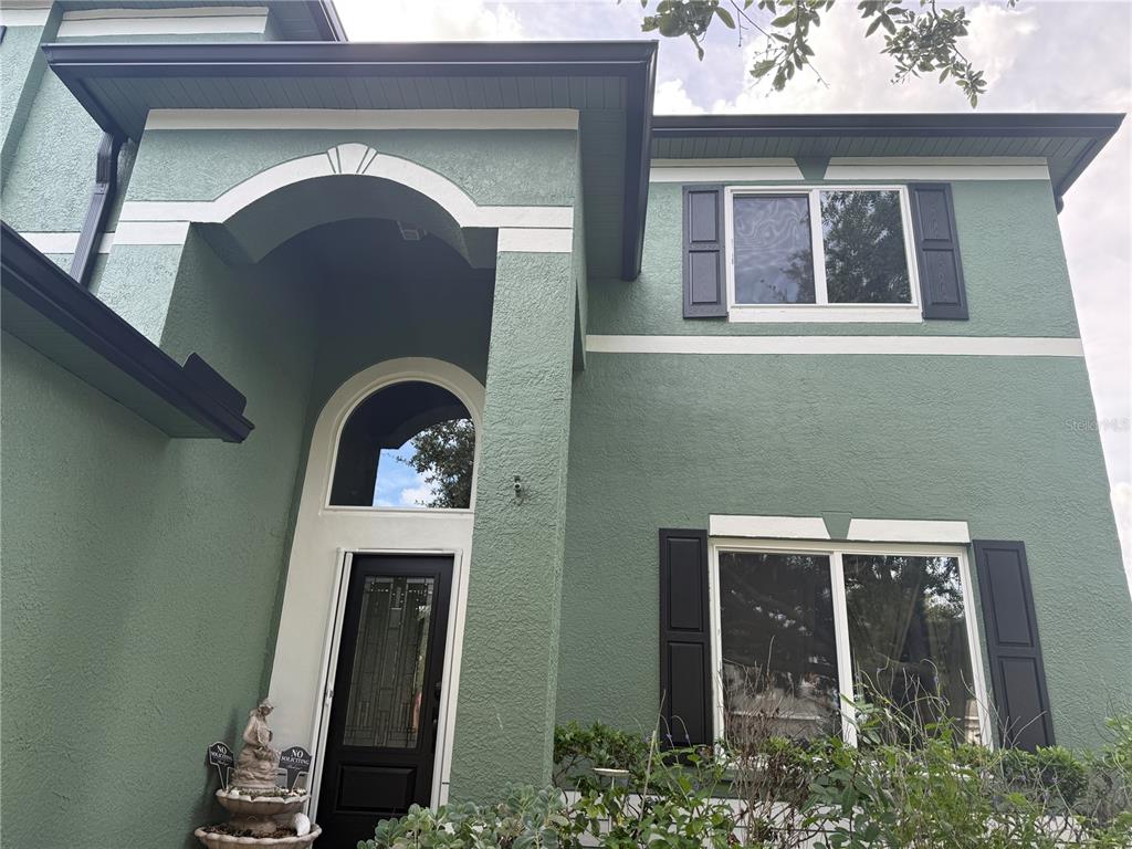 a front view of a house with garden