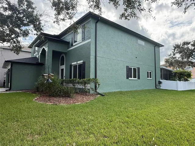 a view of an house with backyard space and garden