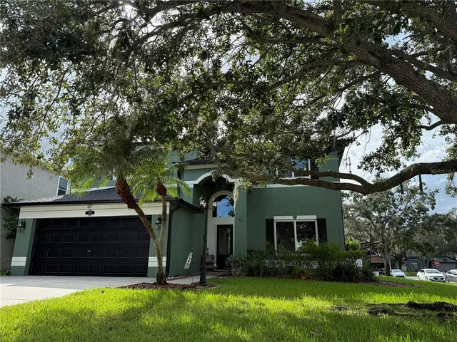 a front view of house with yard and green space