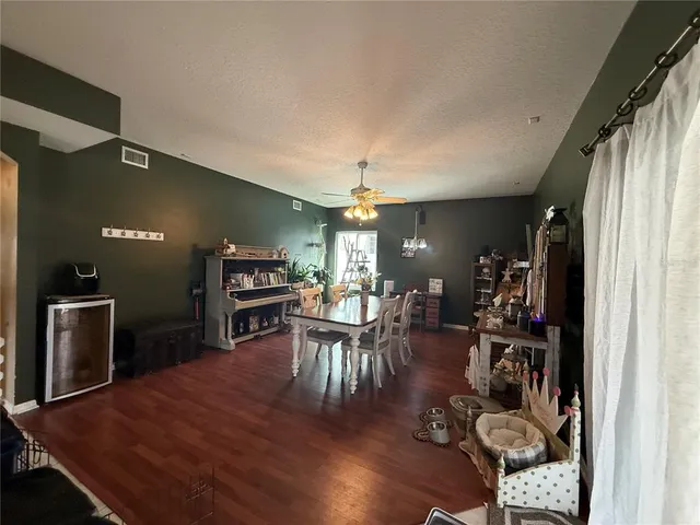 a dining room with furniture and wooden floor