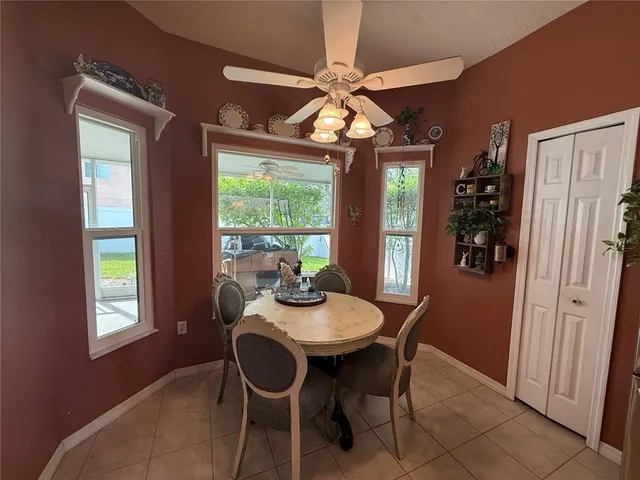 a dining room with furniture a chandelier and window
