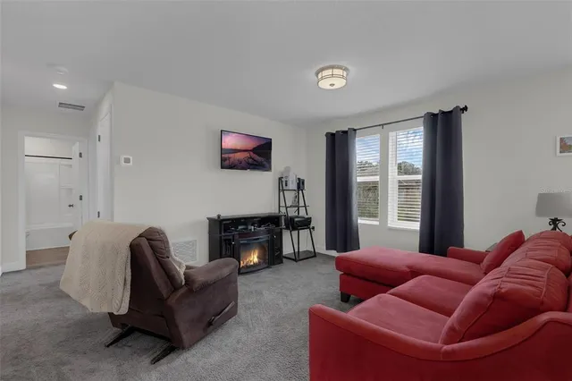 a view of a livingroom with a ceiling fan and window