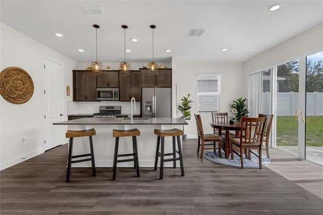 a dining room with furniture and wooden floor