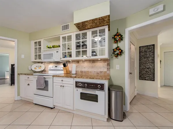 a living room filled with furniture and a floor to ceiling window