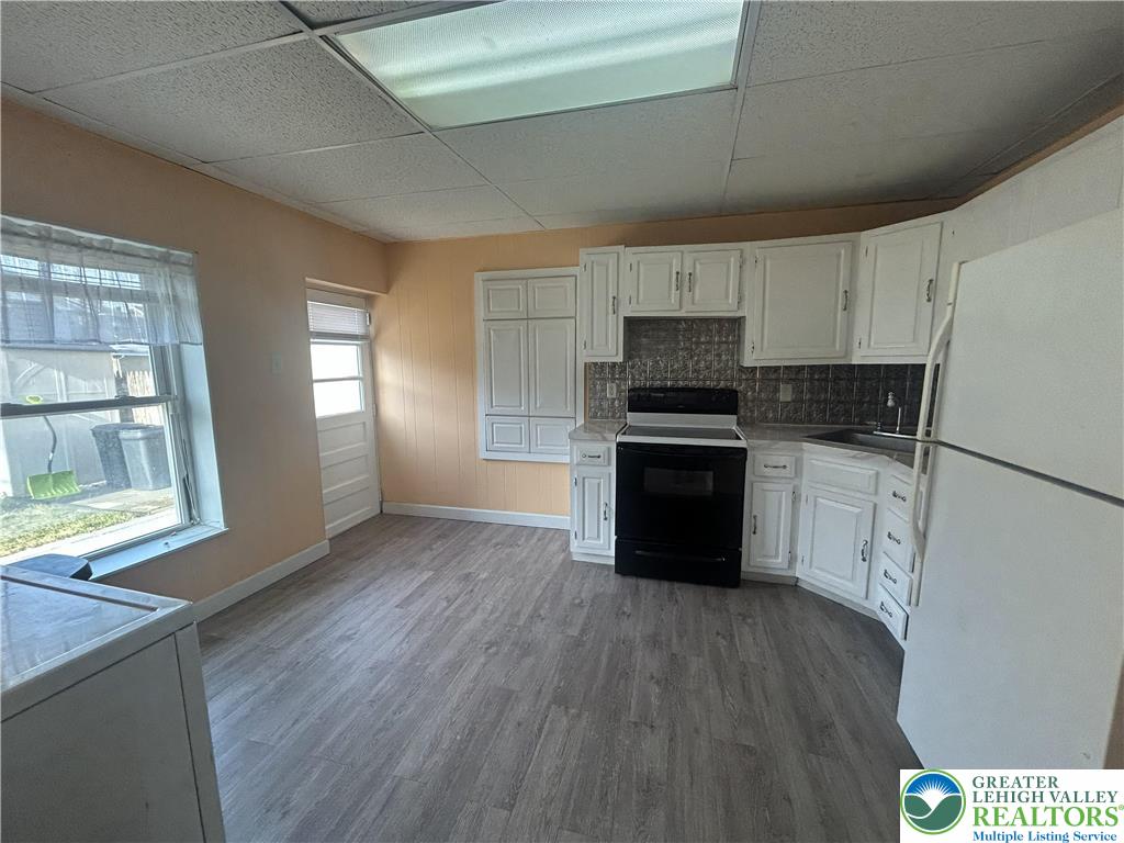 816 North Shell Street Allentown, PA 18109 - Photo 6 of 22 a kitchen with granite countertop a refrigerator and a stove top oven