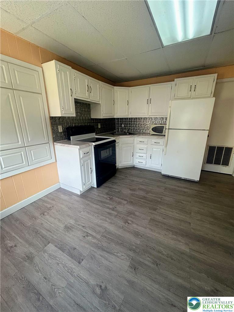 816 North Shell Street Allentown, PA 18109 - Photo 8 of 22 a kitchen with granite countertop a refrigerator and a stove top oven