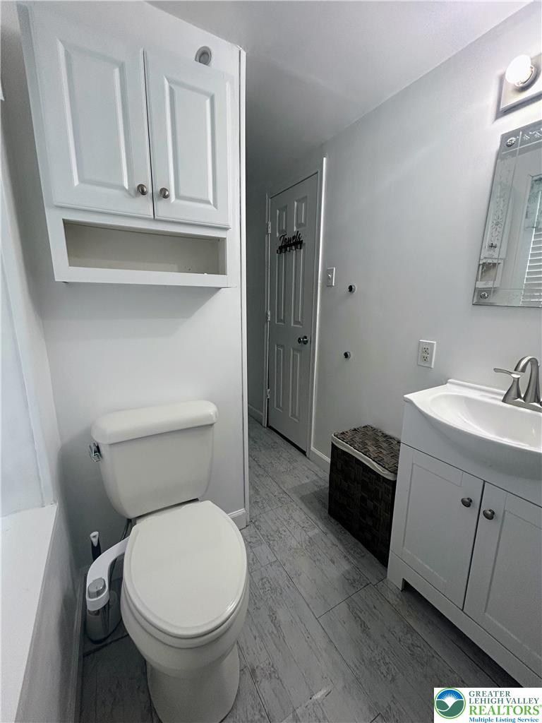 816 North Shell Street Allentown, PA 18109 - Photo 10 of 22 a bathroom with a sink a toilet and vanity