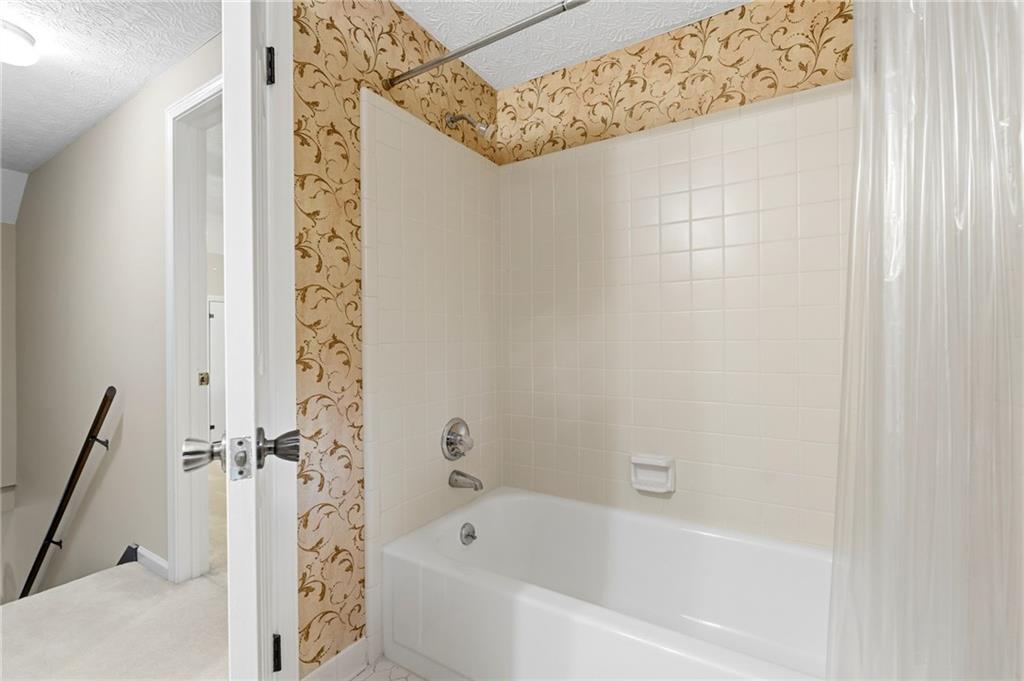 3121 Bonds Lake Road Northwest Conyers, GA 30012 - Photo 24 of 36 a bathroom with a bathtub