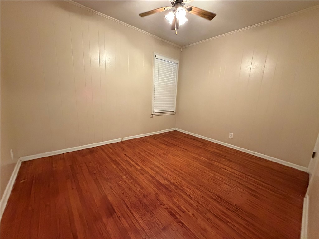1837 Horne Road Corpus Christi, TX 78416 - Photo 11 of 15 an empty room with wooden floor and chandelier fan