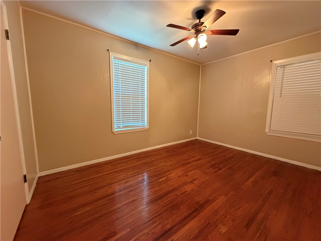 1837 Horne Road Corpus Christi, TX 78416 - Photo 12 of 15 a view of a room with wooden floor and a ceiling fan