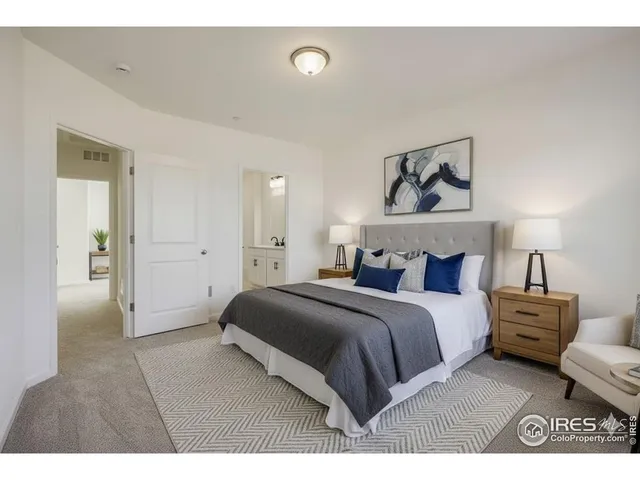 a bedroom with a bed and a painting on the wall