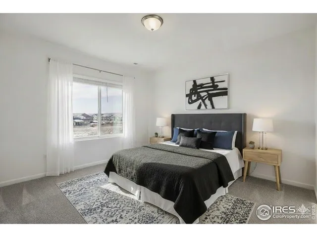 a bedroom with a bed a dresser and a window