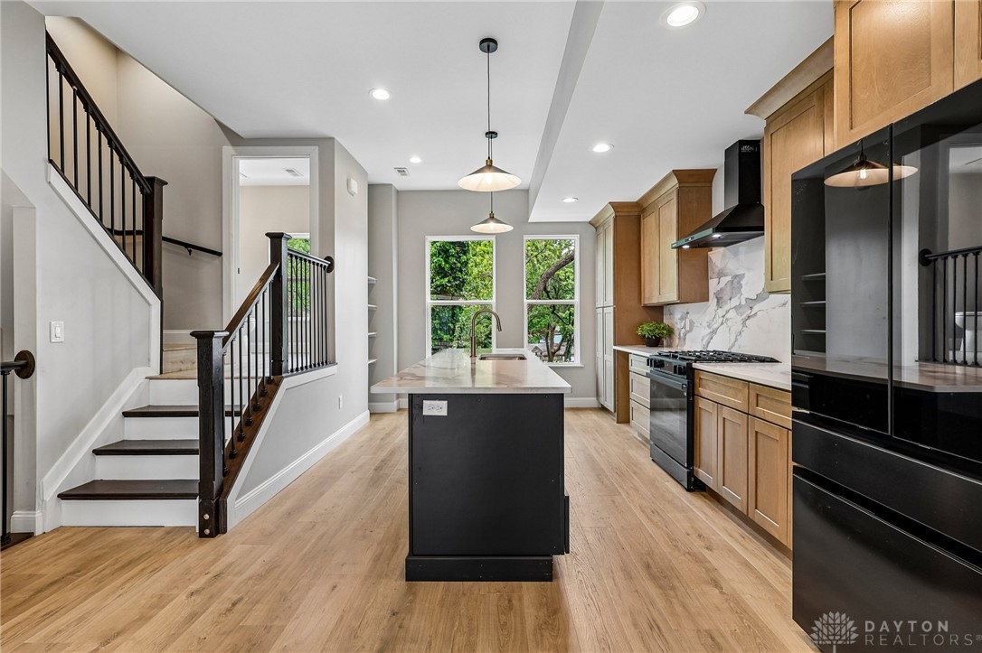 3906 Edwards Road, Unit C Cincinnati, OH 45209 - Photo 12 of 46 This modern kitchen features a spacious island and seamless flow into the living area.