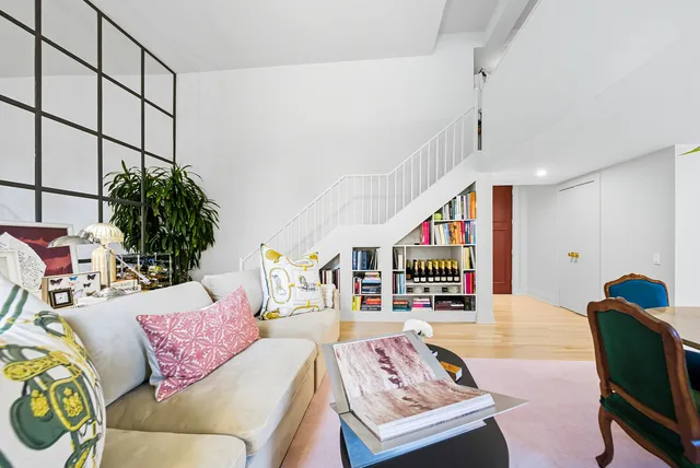 a living room with furniture and a potted plant